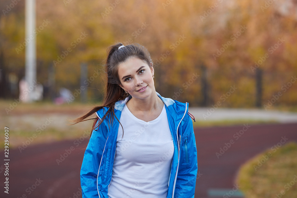 Young athletic girl trains at the stadium. Young athletic girl trains at the stadium.