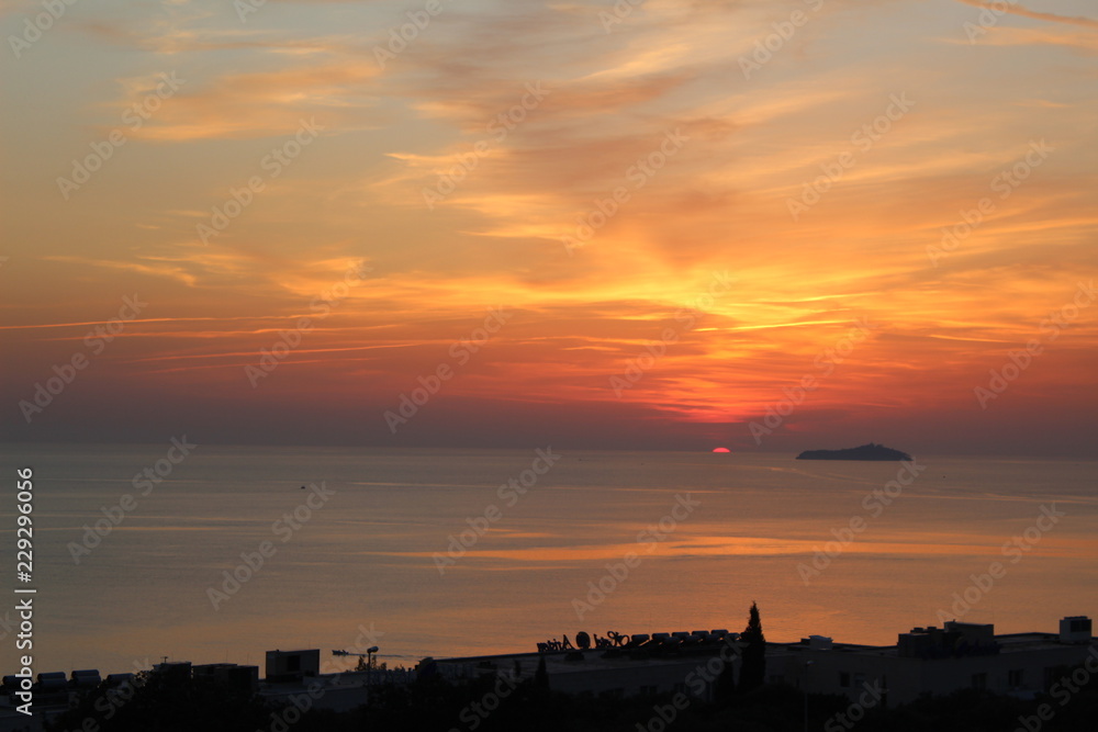 sun setting into the sea landscape portrait