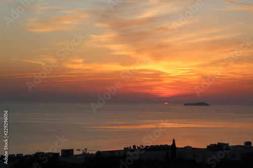 sun setting into the sea landscape portrait