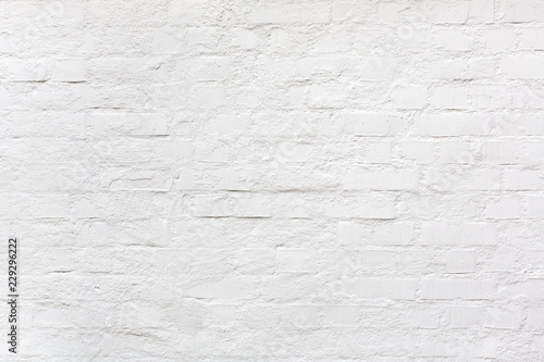 white painted brightly lit brick wall background or texture as a design element for industrial style compositings or wallpaper