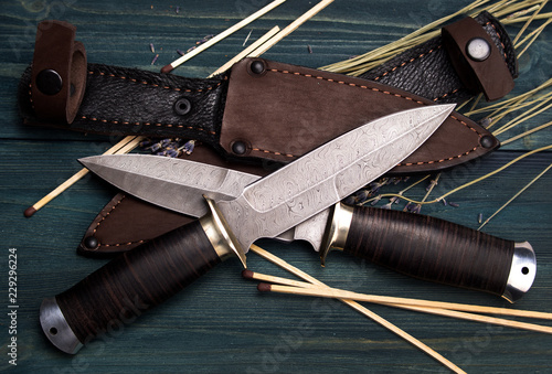 Obraz na plátně Damascus hunting knives with leather sheath on a vintage wooden background