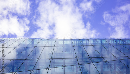 Modern glass building. Cloudy sky background  under view  space.