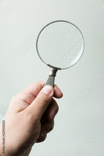 Hand holding Magnifying glass