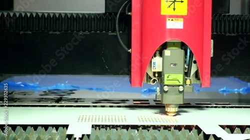 Close-up a laser cutting machine is working with a steel plate until it sparks on smart factory, industry 4.0