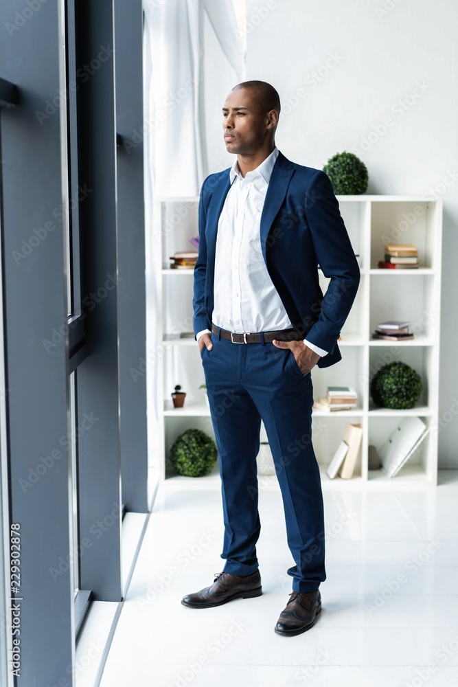 Handsome cheerful african american executive business man at the workspace office. Handsome cheerful african american executive business man at the workspace office.