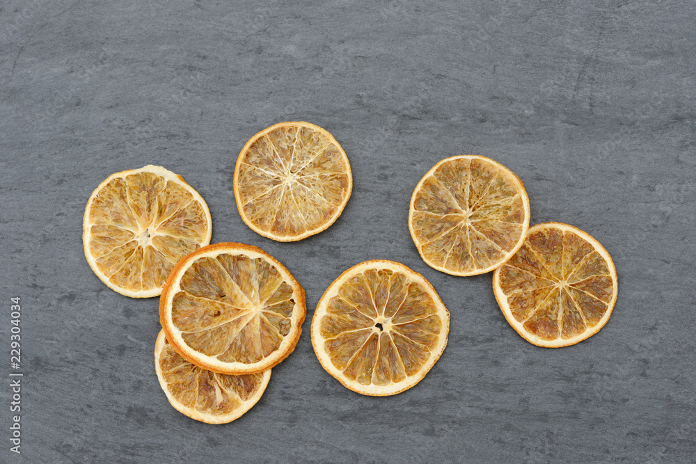 orangen slices lying on black slate orangen slices lying on black slate