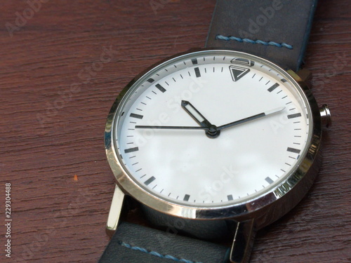 Wallpaper Mural a white watch on the brown background Torontodigital.ca