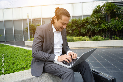 middle eastern business man using laptop outdoor