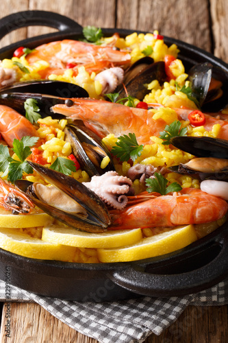 Closeup of traditional Spanish paella with seafood in a pan. vertical