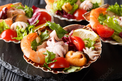 Healthy snack salad of seafood shrimp, baby octopus, mussels and scallops are...