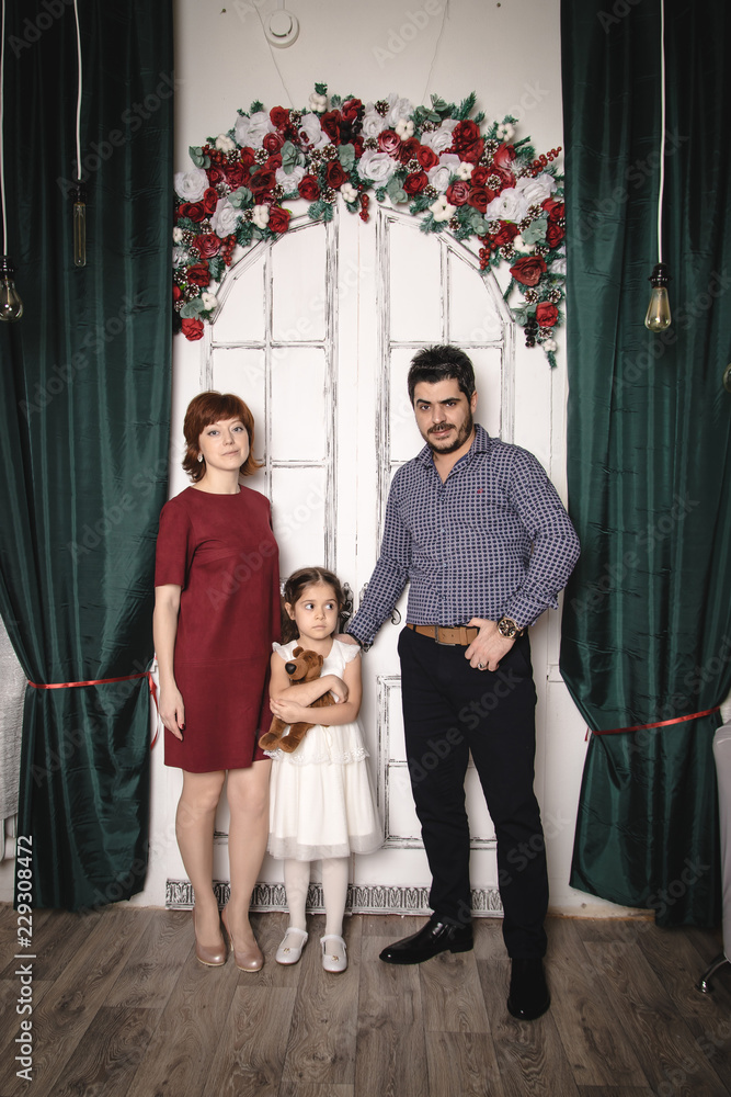 Family with Russian mom, Turkish dad and their daughter are in a room  decorated for Christmas and new year Stock Photo | Adobe Stock