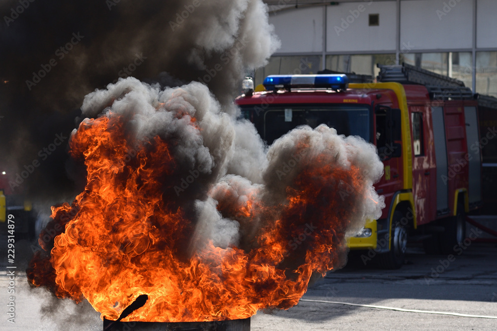 Fire in front of fire truck during demonstrative exercise of firemen skills Fire in front of fire truck during demonstrative exercise of firemen skills
