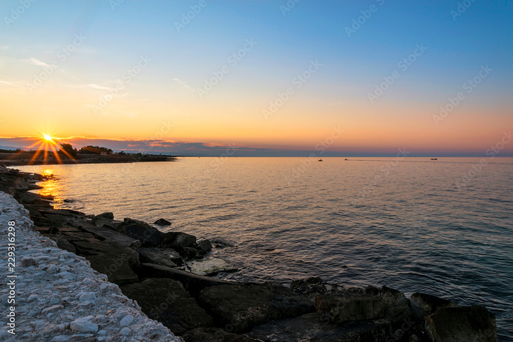 Fototapeta premium Sunset in Villanova port harbour Marina Ostuni on the Adriatic sea