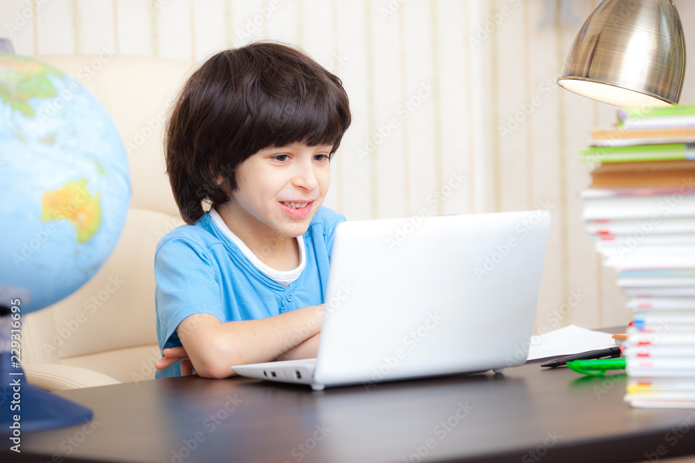 smiling boy looking at a computer monitor smiling boy looking at a computer monitor