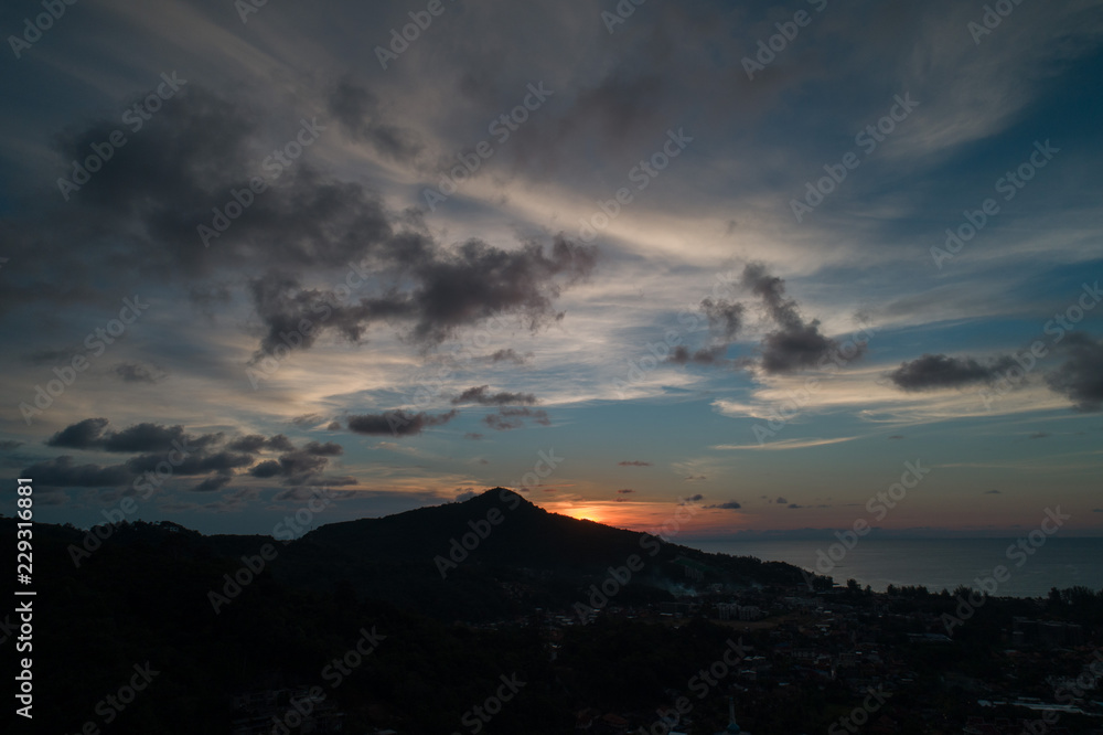 Aerial drone view of beautiful sunset on the island with sea in the background