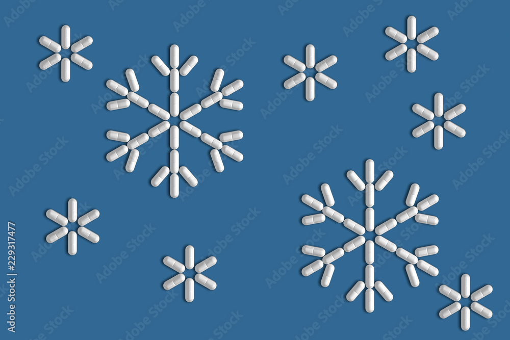 Background of a variety of tablets scattered on a blue background in the form of a silhouette snowflakes 3d illustration Background of a variety of tablets scattered on a blue background in the form of a silhouette snowflakes 3d illustration