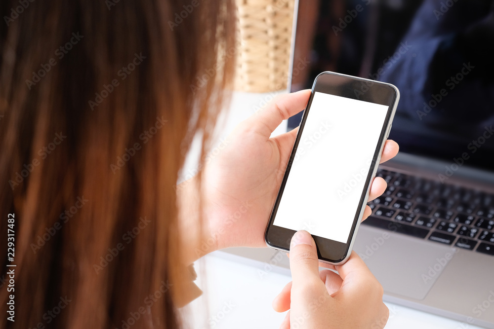 Top view a woman using mockup smartphone mobile with clipping path.