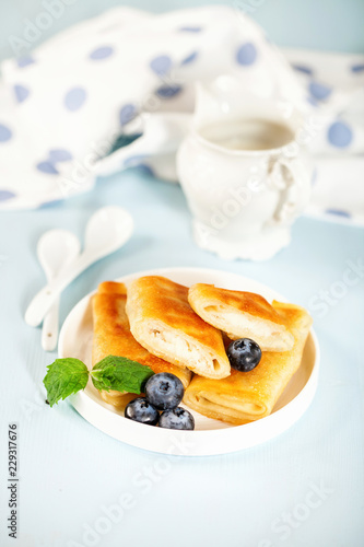 Roll pancakes with cottage cheese and berries