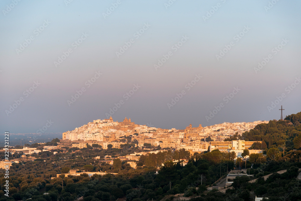 Panoramic view of the medieval white village of Ostuni at sunset