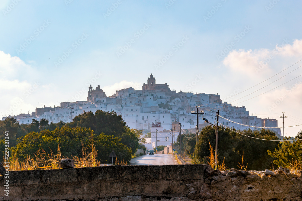Panoramic shape of the medieval white village of Ostuni at sunset