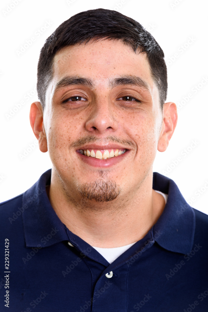 Obraz premium Face of young happy Hispanic man smiling 