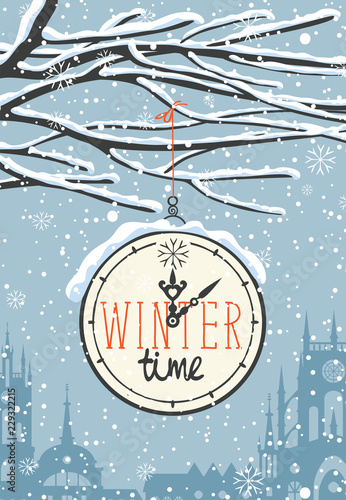 Vector winter landscape with words winter time on the clock, with snow-covered tree branches on the background of the evening sky with snowflakes and the old European town