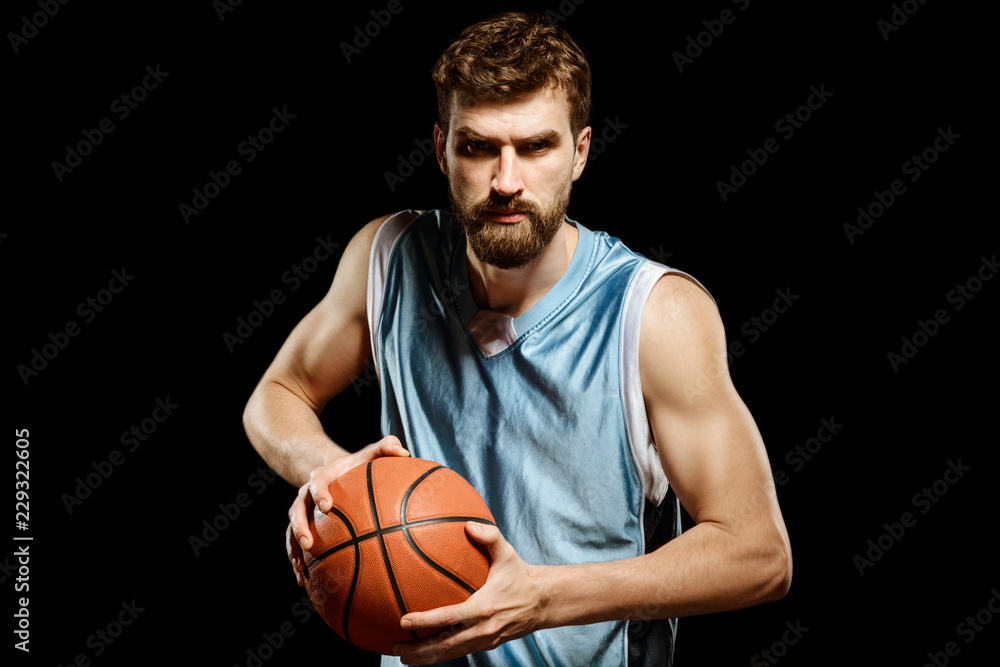 Furious basketball player on black