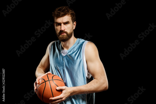 Muscular man playing basketball