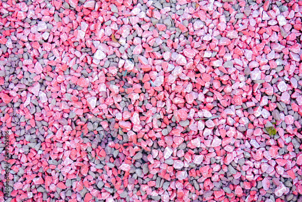 Small pink and grey pebble background. Top view texture Small pink and grey pebble background. Top view texture