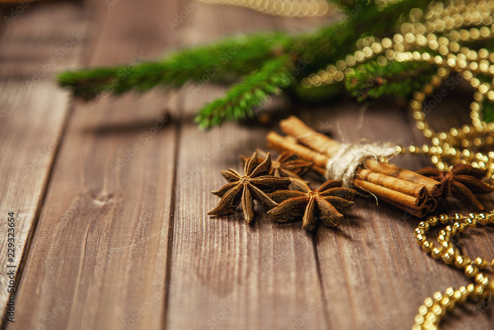 Spices for mulled wine with Christmas tree on wooden background Spices for mulled wine with Christmas tree on wooden background