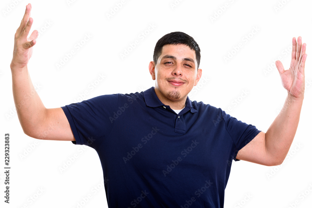 Studio shot of young Hispanic man with open arms Studio shot of young Hispanic man with open arms