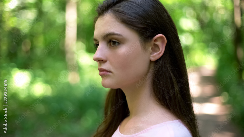 Beautiful brunette looking seriously, clean skin and natural makeup, closeup Beautiful brunette looking seriously, clean skin and natural makeup, closeup