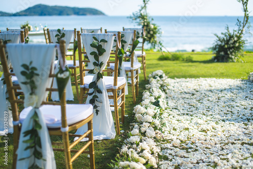 Chair decorated with flowers in Wedding ceremony.