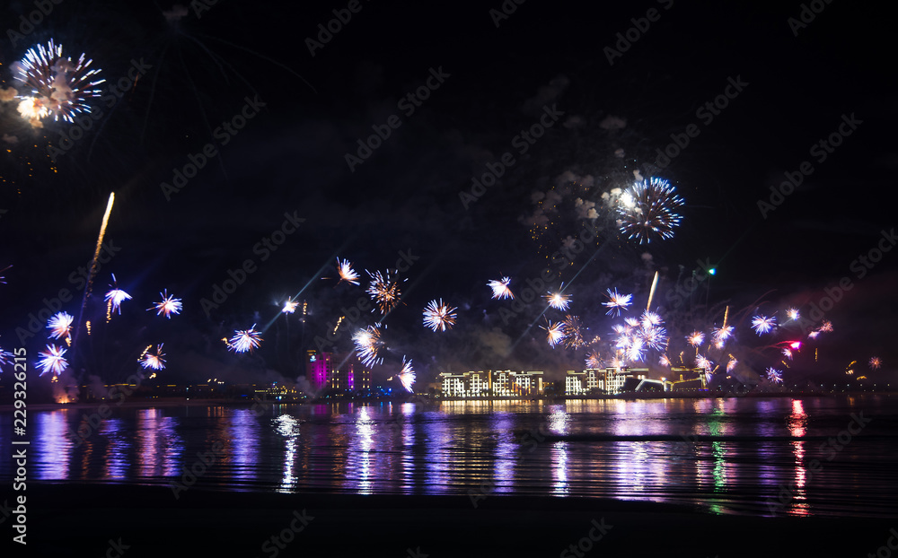 Festive firework over seaside water