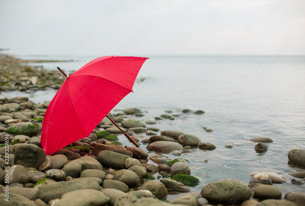 Loneliness Concept.  Red Umbrella Over Deserted Beach. Background. Copy Space Solitude Depression New start Procrastination
