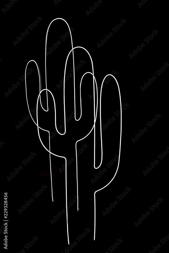 Naklejka premium Neon light in cactus shape on black background