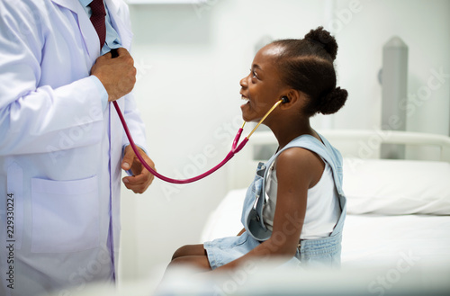 Friendly pediatrician entertaining his patient photo