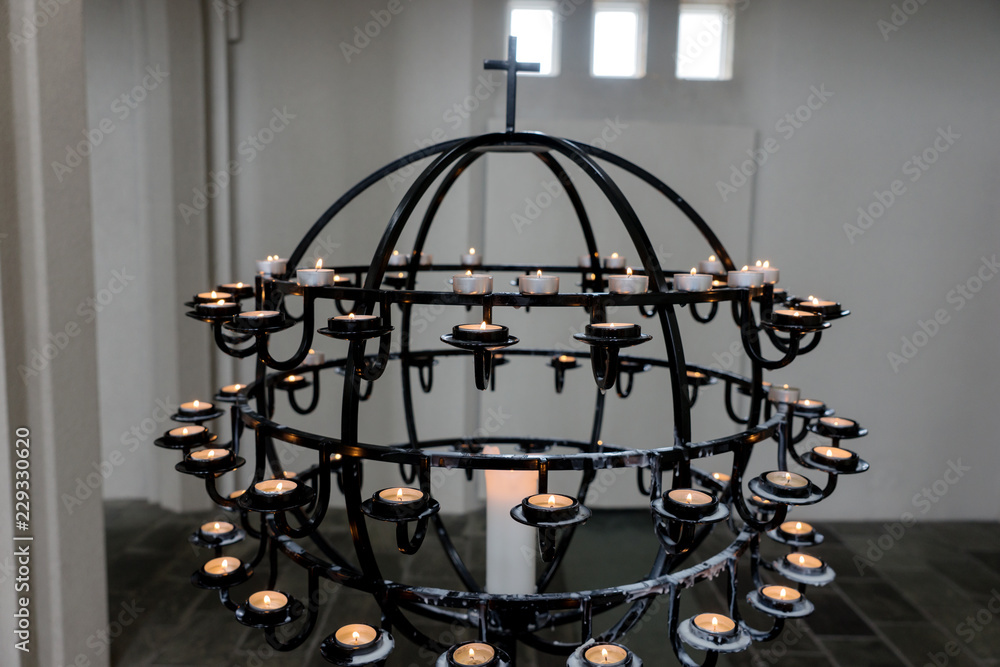 Burning candles on a chandelier in the church