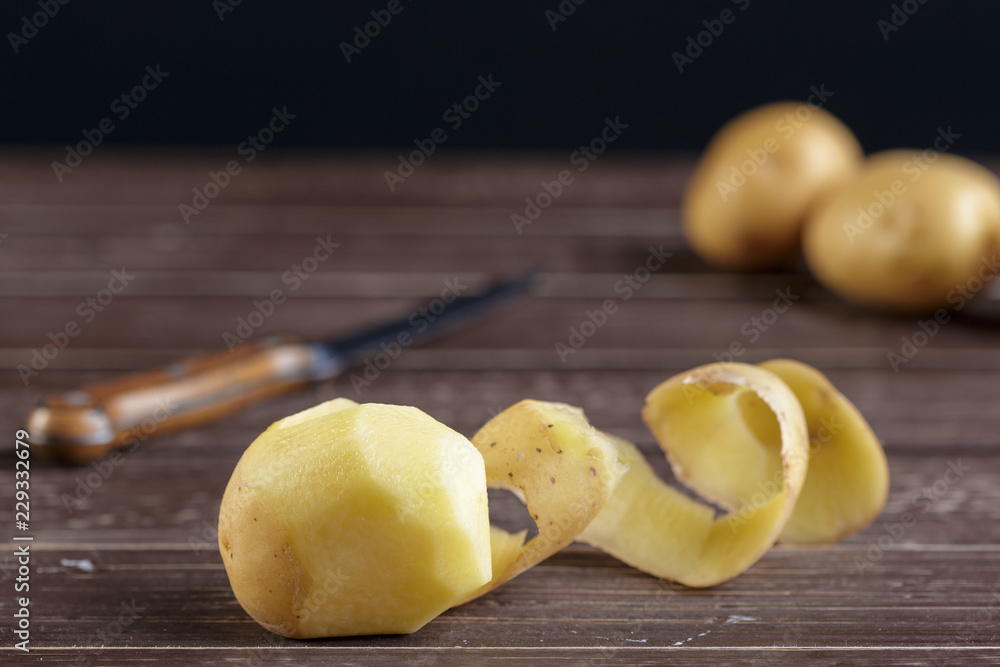 Fresh potatoes on the wood background
