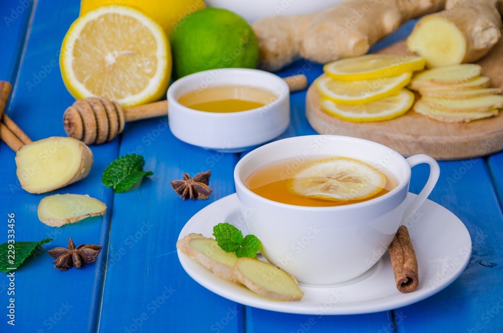 Ginger tea with lemon and honey on blue wooden background Ginger tea with lemon and honey on blue wooden background