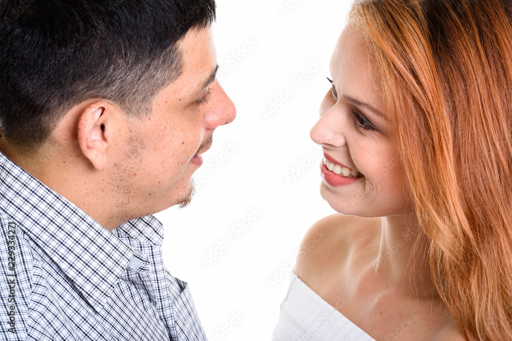Young Hispanic couple smiling and looking at each other in love Young Hispanic couple smiling and looking at each other in love