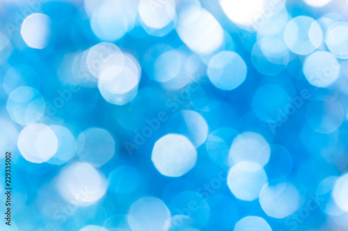 Abstract festive bright background with blue bokeh effect with copy space