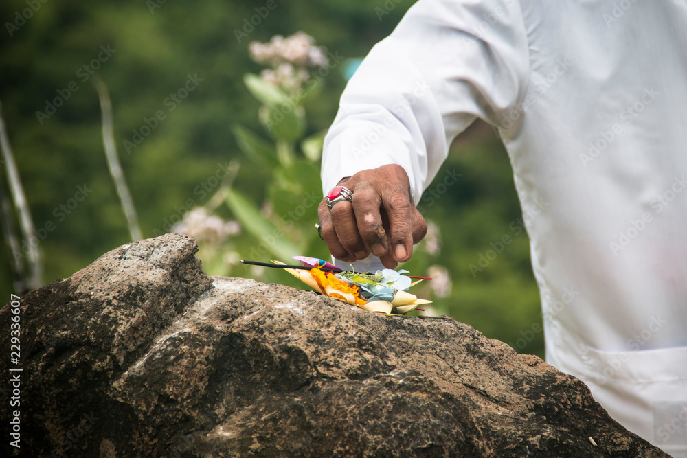 A hindu priest performing offerings in a temple in Pemuteran in Bali, Indonesia