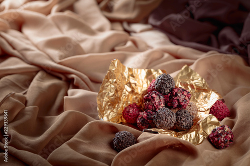 Various chocolates in golden foil.