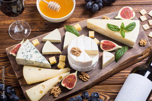 Cheeseboard with cheese brie , parmesan , camembert and dorblu photo