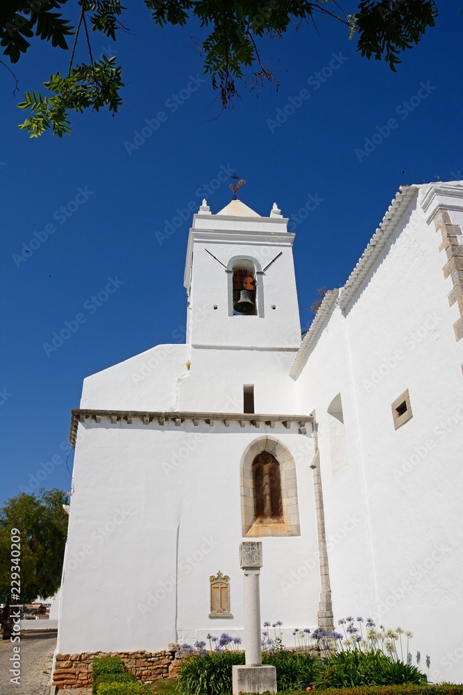 View of the Santa Maria do Castelo church (Igreja de Santa Maria do Castelo) bell tower, Tavira, Algarve, Portugal.