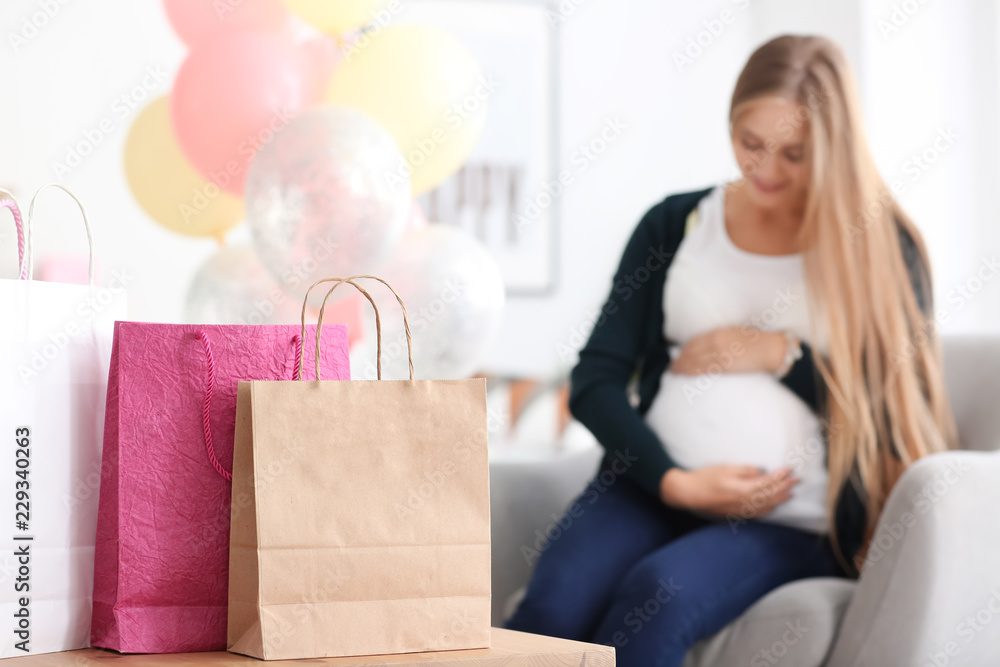 Beautiful pregnant woman with gifts for baby shower party at home Beautiful pregnant woman with gifts for baby shower party at home