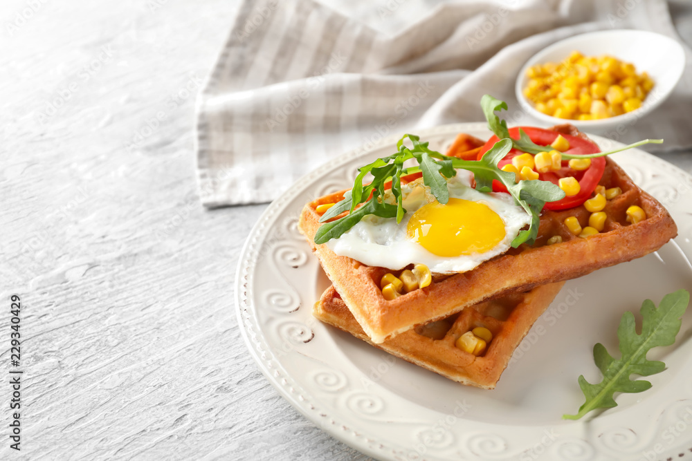 Delicious waffles with fried egg and vegetables on plate Delicious waffles with fried egg and vegetables on plate