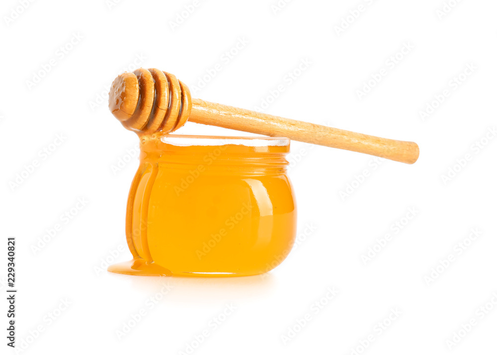 Jar of honey with dipper on white background Jar of honey with dipper on white background