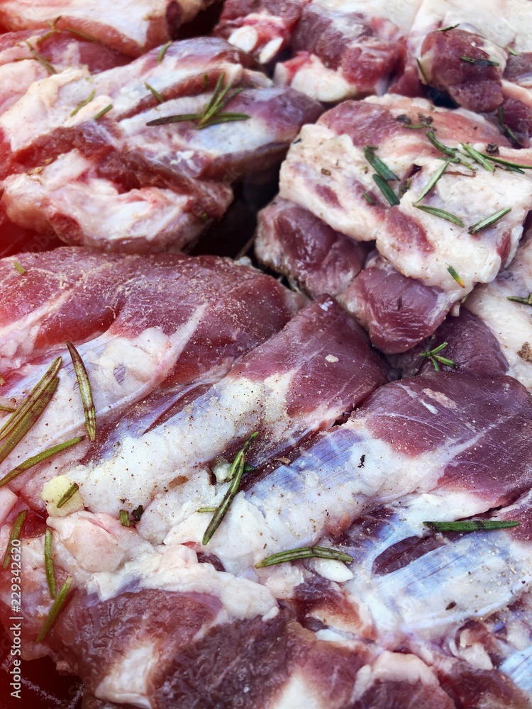 detail of pork meat with rosemary and garlic